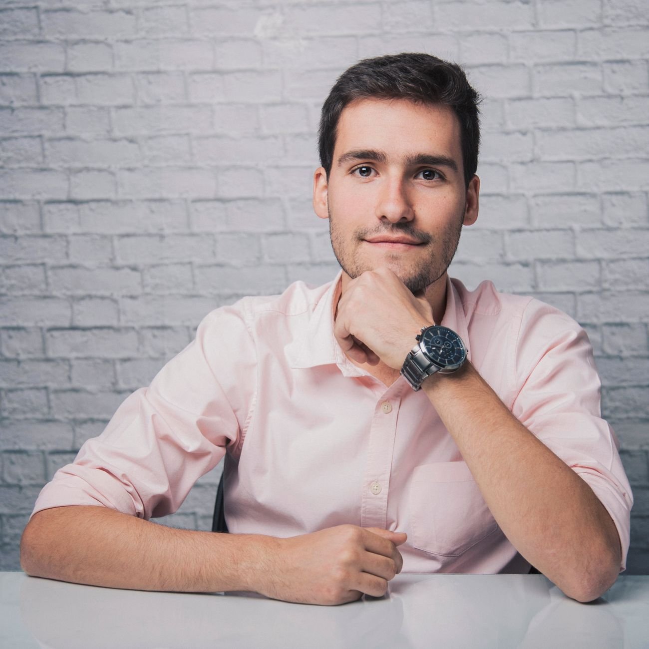 Positive young founder smiling at camera in modern workspace